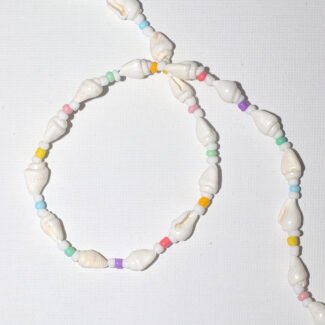 Close-up of a handmade shell bead necklace with colorful beads, reflecting a tropical beach-inspired aesthetic.